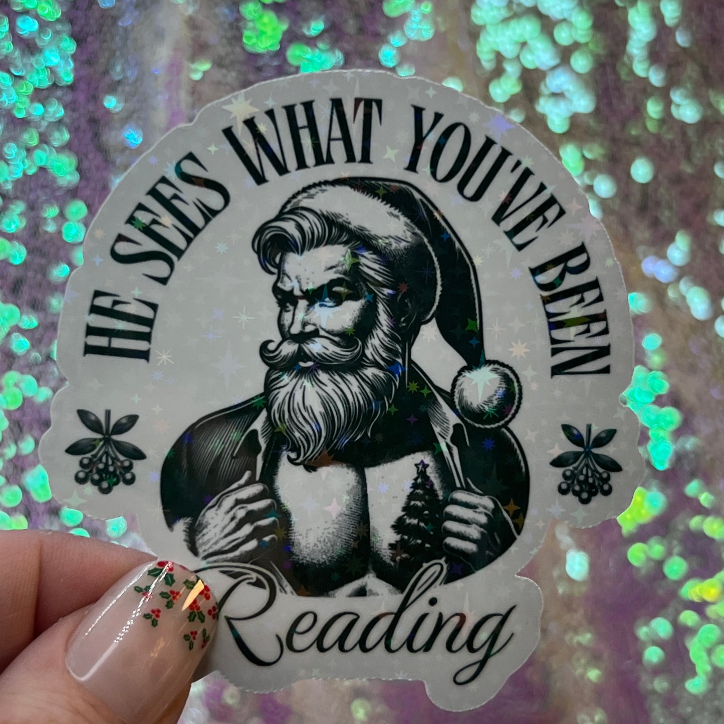 He Sees What You’ve Been Reading Holographic Santa Sticker – Book Lover Holiday Sticker