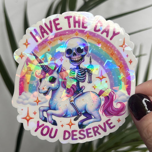 Holographic "Have the Day You Deserve" Skeleton Riding Unicorn Decal Middle Finger Rainbow Sticker | Sassy Funny Holographic Sticker